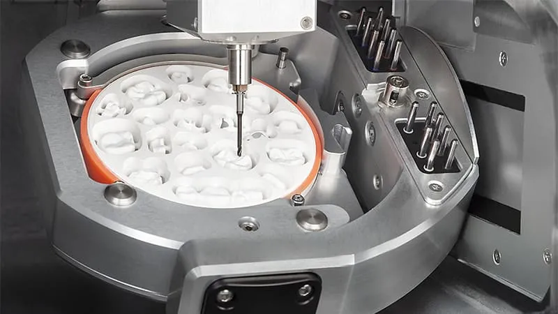Dental CNC machinery in the foreground at a production centre